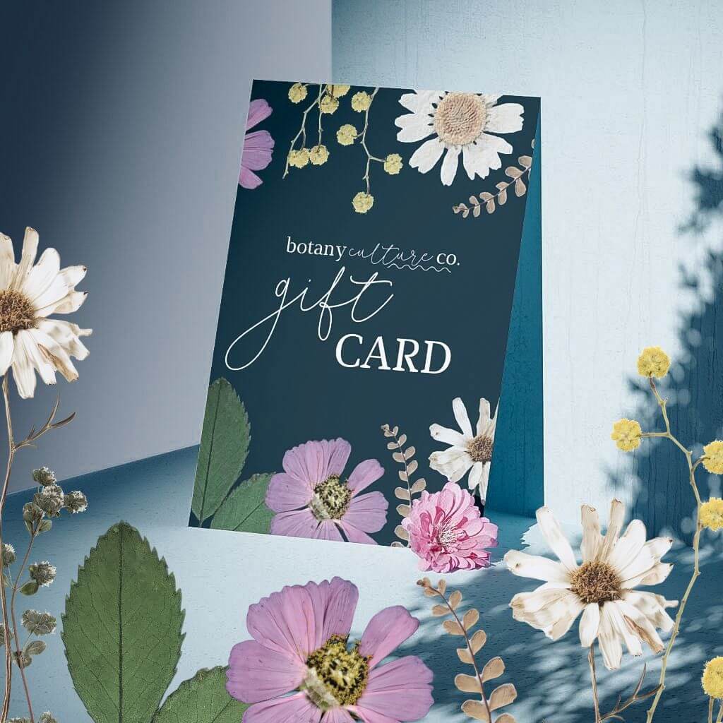 mock up of a botany culture co. digital gift card with pressed flowers