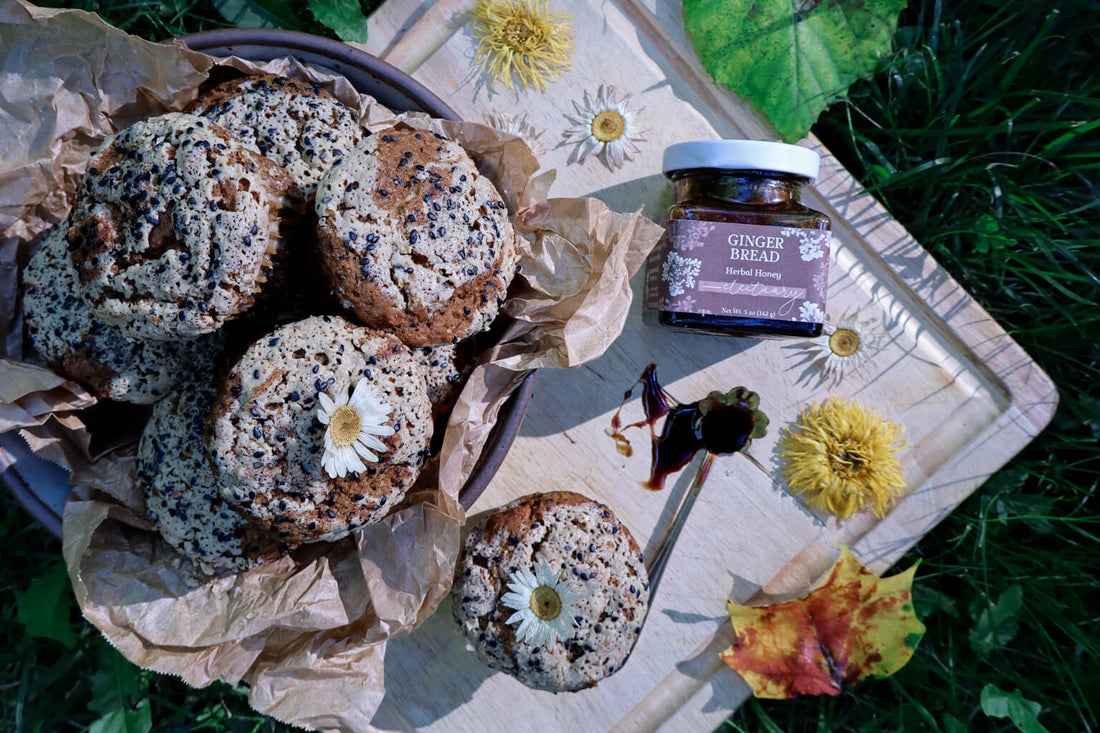 a bowl of gingerbread muffins on a cutting board with a jar of gingerbread honey