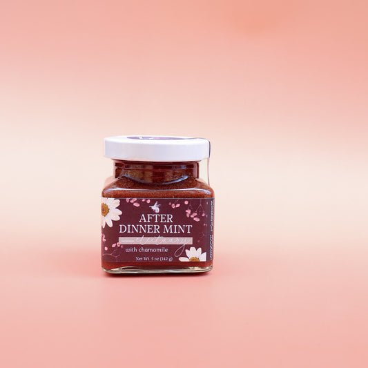 Jar of 'After Dinner Mint' Herbal Honey for digestion on a gradient pink background