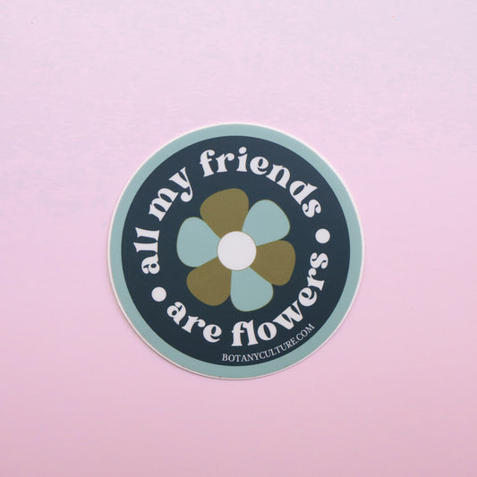 Green, blue, and white circular sticker design with retro flower in middle surrounded by the text "all my friends are flowers"