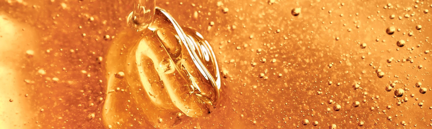 Close-up of a golden honey with air bubbles in it