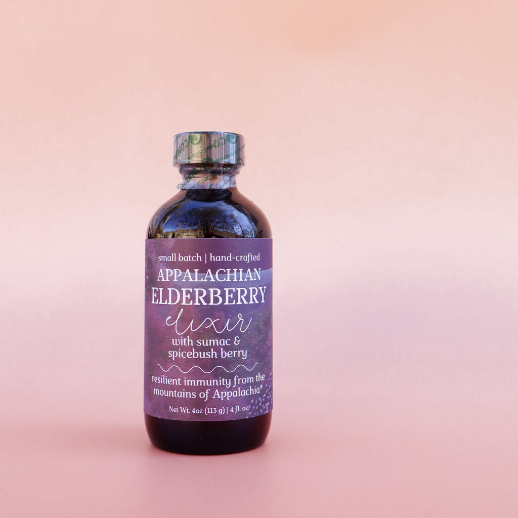 Bottle of 'Appalachian Elderberry Elixir: Immune Support' on a pink background
