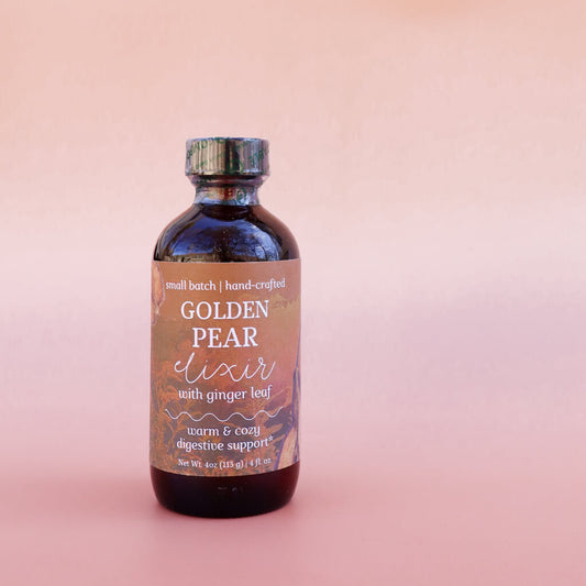 Bottle of Golden Pear Herbal elixir: warm and cozy digestive support' with ginger leaf on a pink background