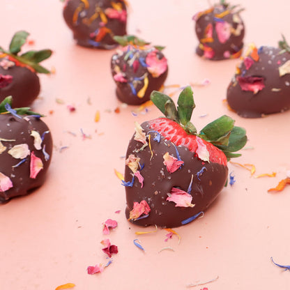 dark chocolate dipped strawberries decorated with edible flower finishing salt