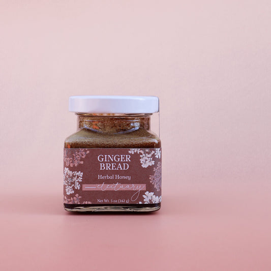 Jar of Ginger Bread Herbal Honey on a pink background