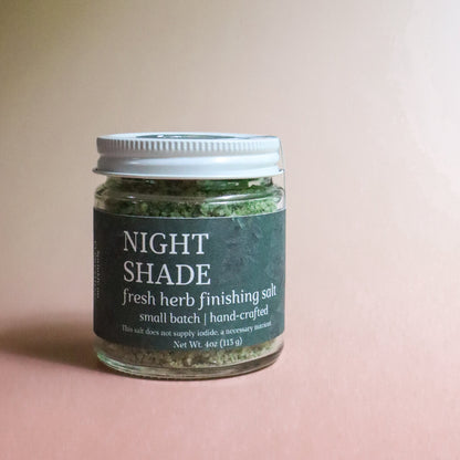 Jar of 'Night Shade' fresh herb finishing salt on a pink background