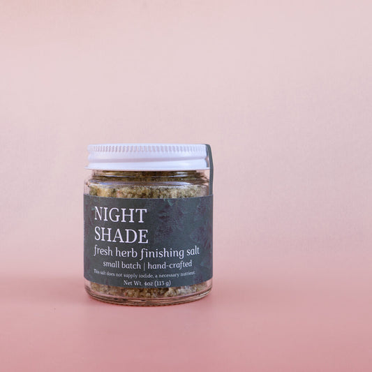 Jar of 'Night Shade' fresh herb finishing salt on a pink background
