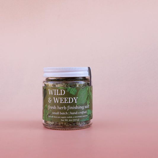 Jar of 'Wild & Weedy' fresh herb finishing salt on a pink background