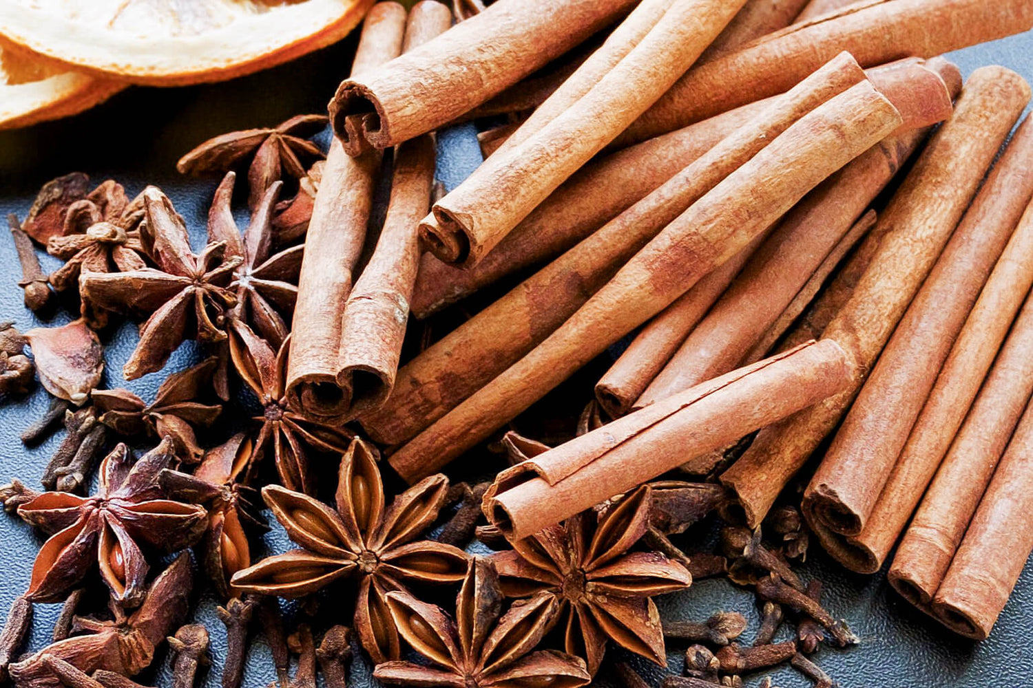 Cinnamon sticks and star anise on a dark surface