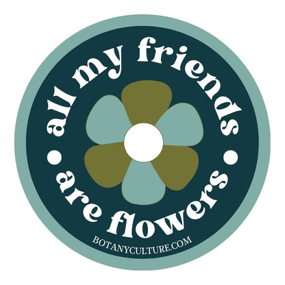 Graphic of a circular sticker design with a retro flower design in the center and text 'All my friends are flowers' on a dark green background.