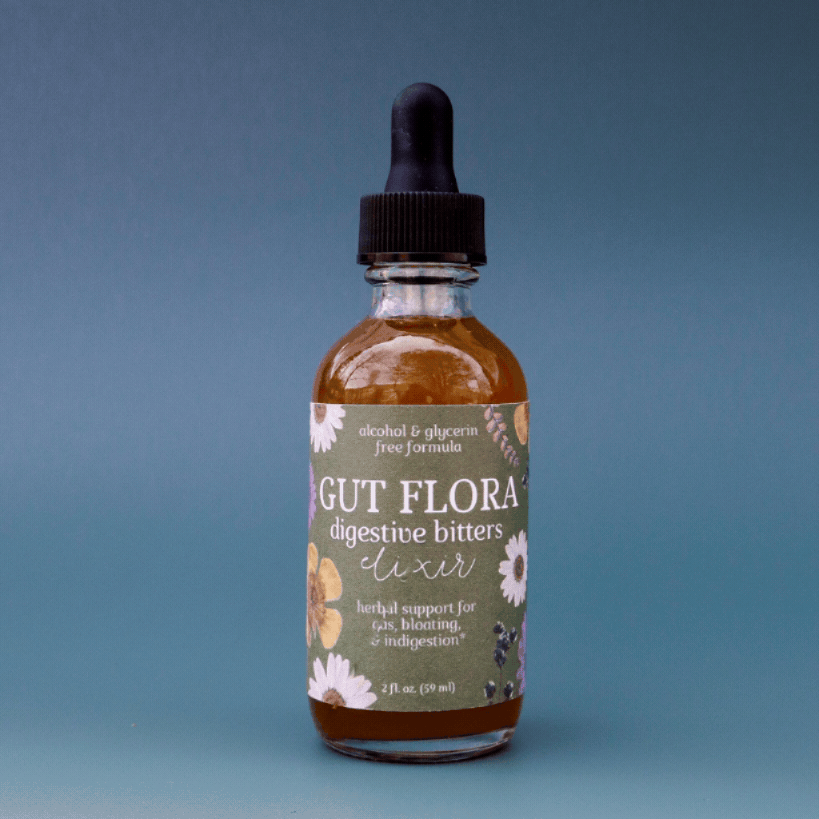 a gif showing a bottle of Gut Flora non-alcoholic dandelion bitters spinning in a circle against a blue background