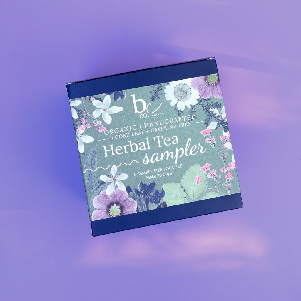 a box with a label that reads "Herbal Tea Sampler" on a purple background