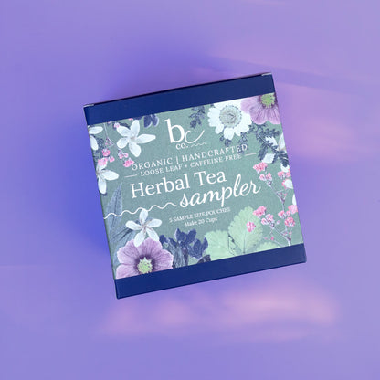 a box with a label that reads "Herbal Tea Sampler" on a purple background