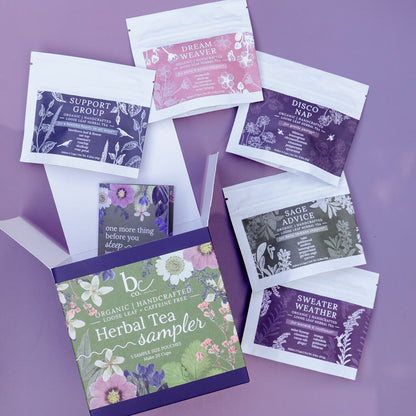 an herbal tea sampler box opened with 5 herbal tea sample pouches arranged on a purple background