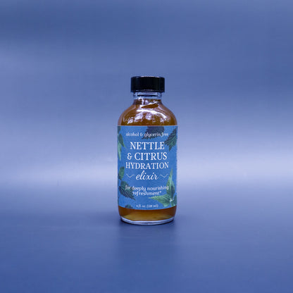 Bottle of Nettle & Citrus Hydration Elixir on a gradient blue background