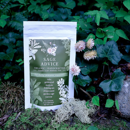 Tea package labeled 'Sage Advice Organic Loose-Leaf Herbal Tea' surrounded by green leaves and flowers