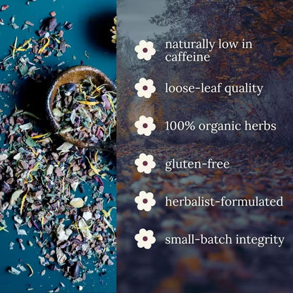 Loose-leaf herbal tea blend spilled from a small ceramic spoon on a dark teal surface, with a blurred forest background and white text listing benefits: naturally low in caffeine, loose-leaf quality, 100% organic herbs, gluten-free, herbalist-formulated, and small-batch integrity.